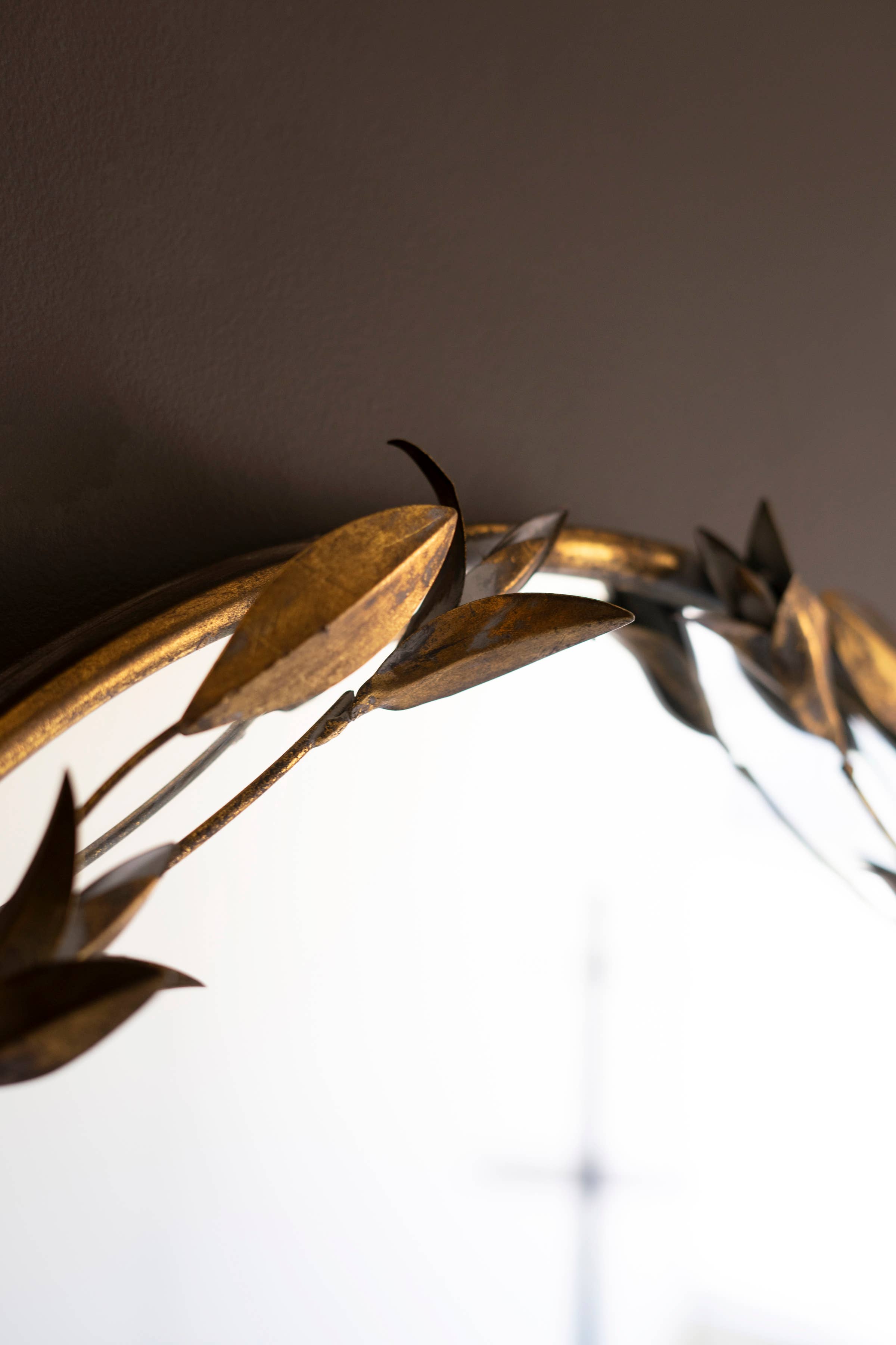 TALL ARCHED ANTIQUE BRASS FRAMED MIRROR WITH LEAVES